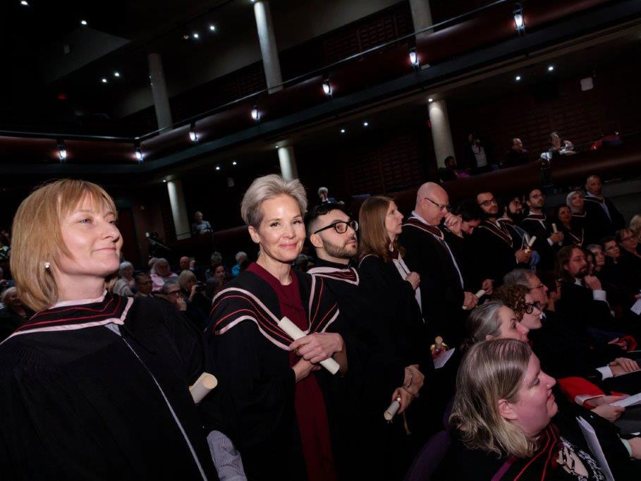 Emmanuel graduates holding diplomas