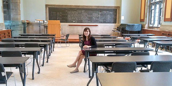 Boram Lee sitting in an Emmanuel College classroom. 