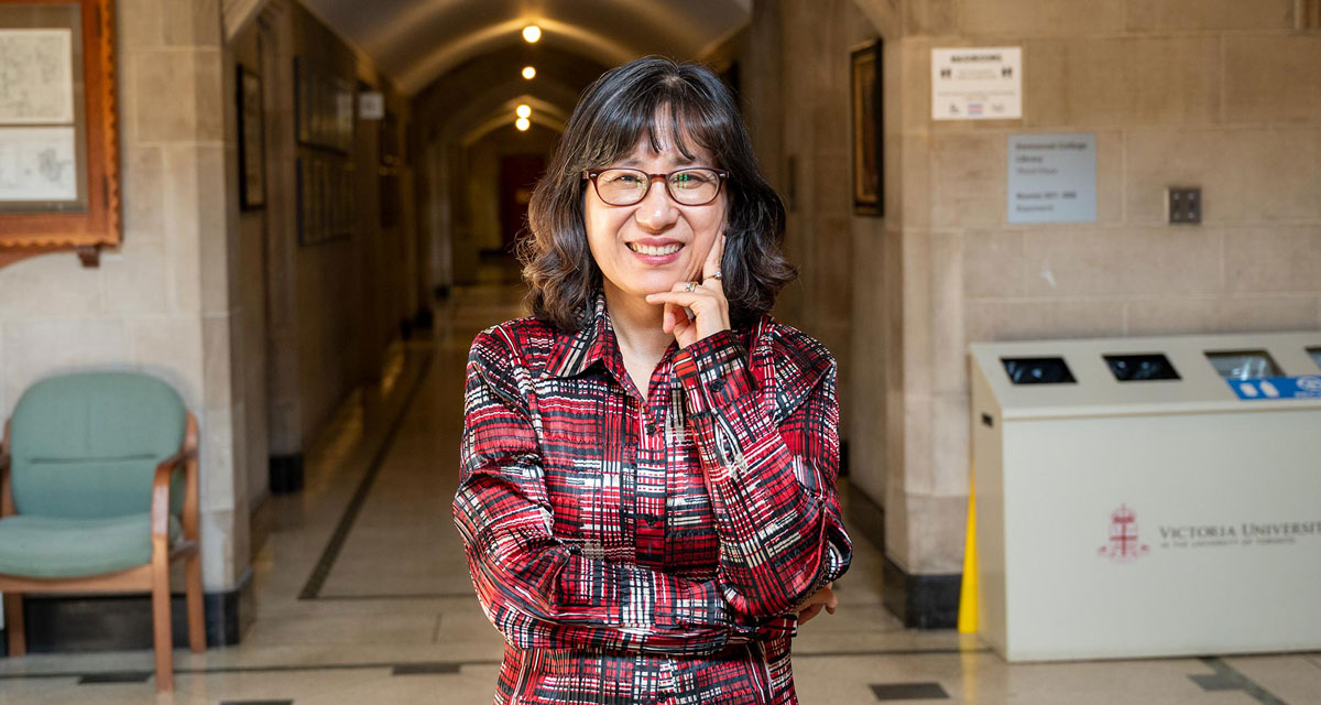 Principal HyeRan Kim-Cragg standing in the hallway of Emmanuel College.